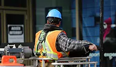 Worker with blue hard hat in cherry picker Australia